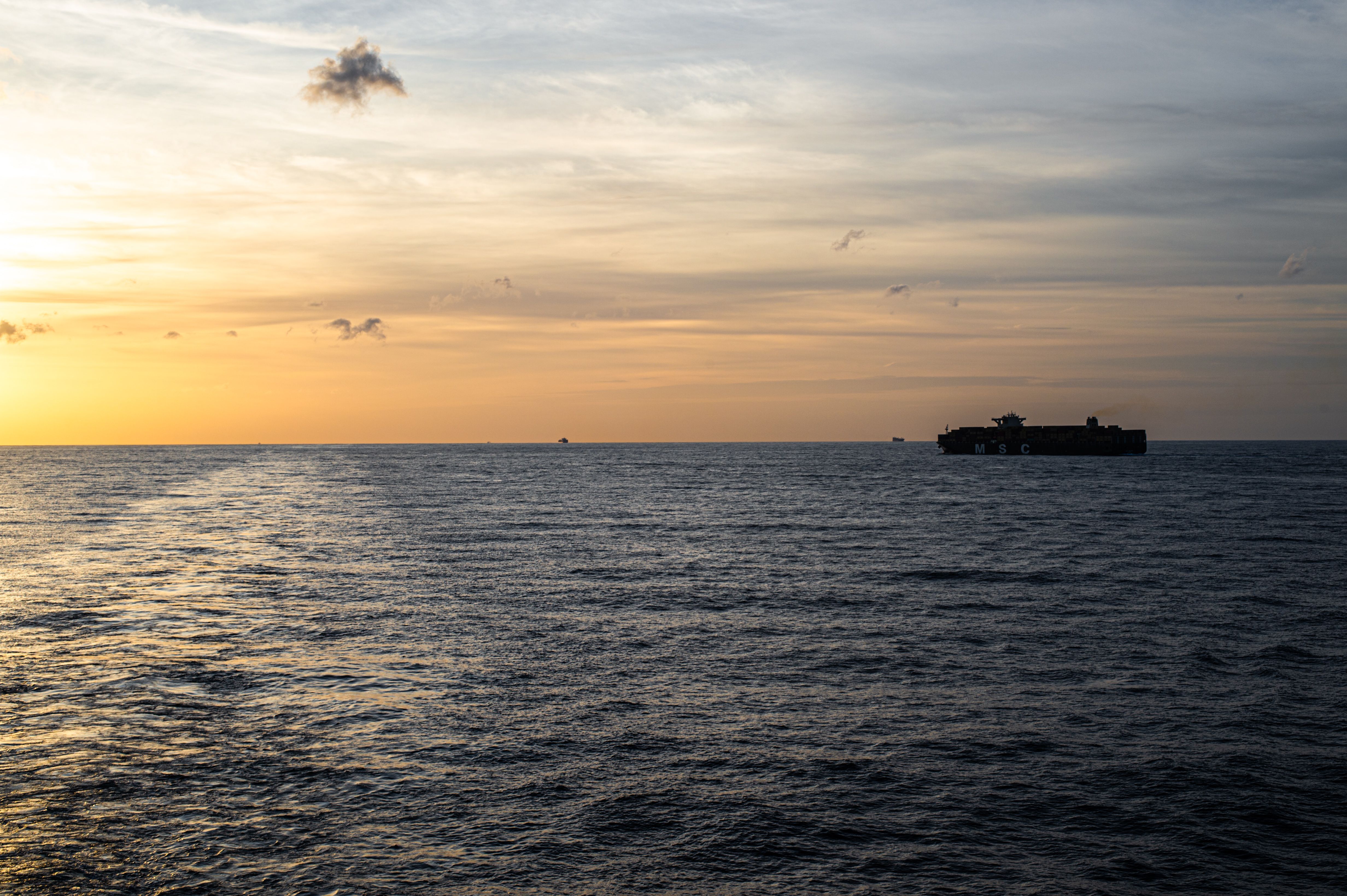 Cargo ship on tranquil ocean