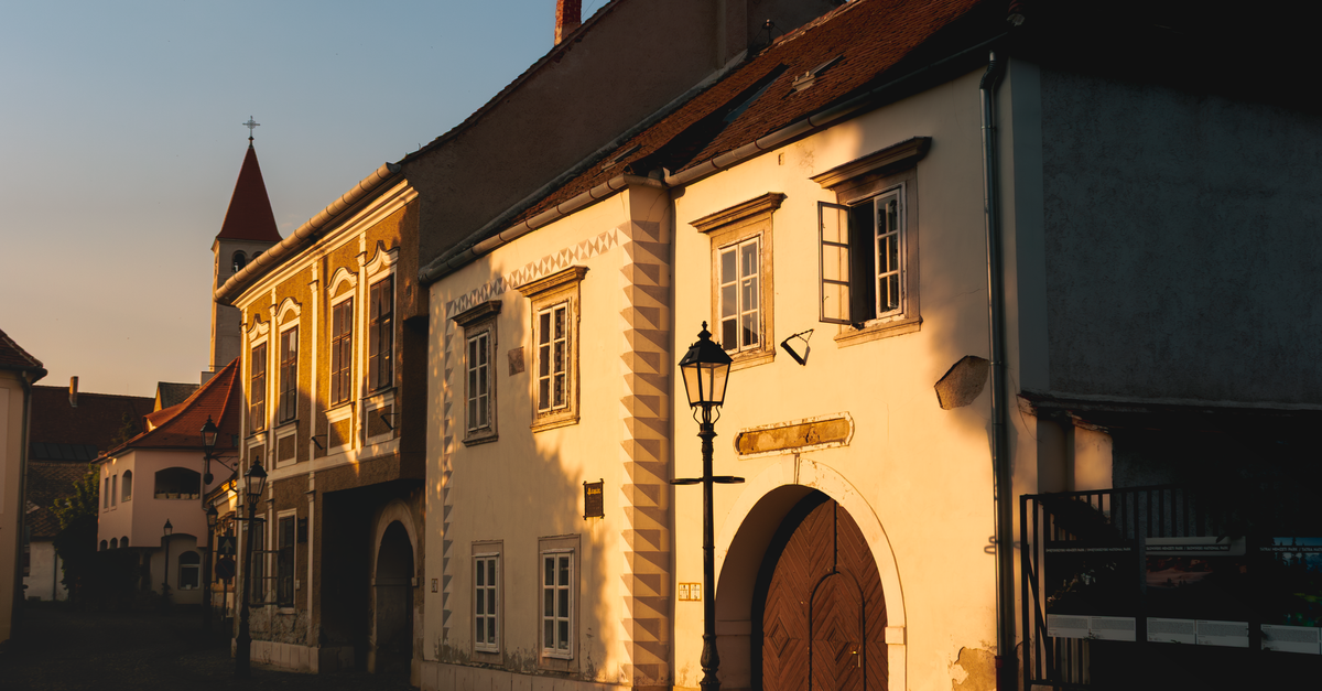 quiet cobblestone street in a European neighborhood at golden hour