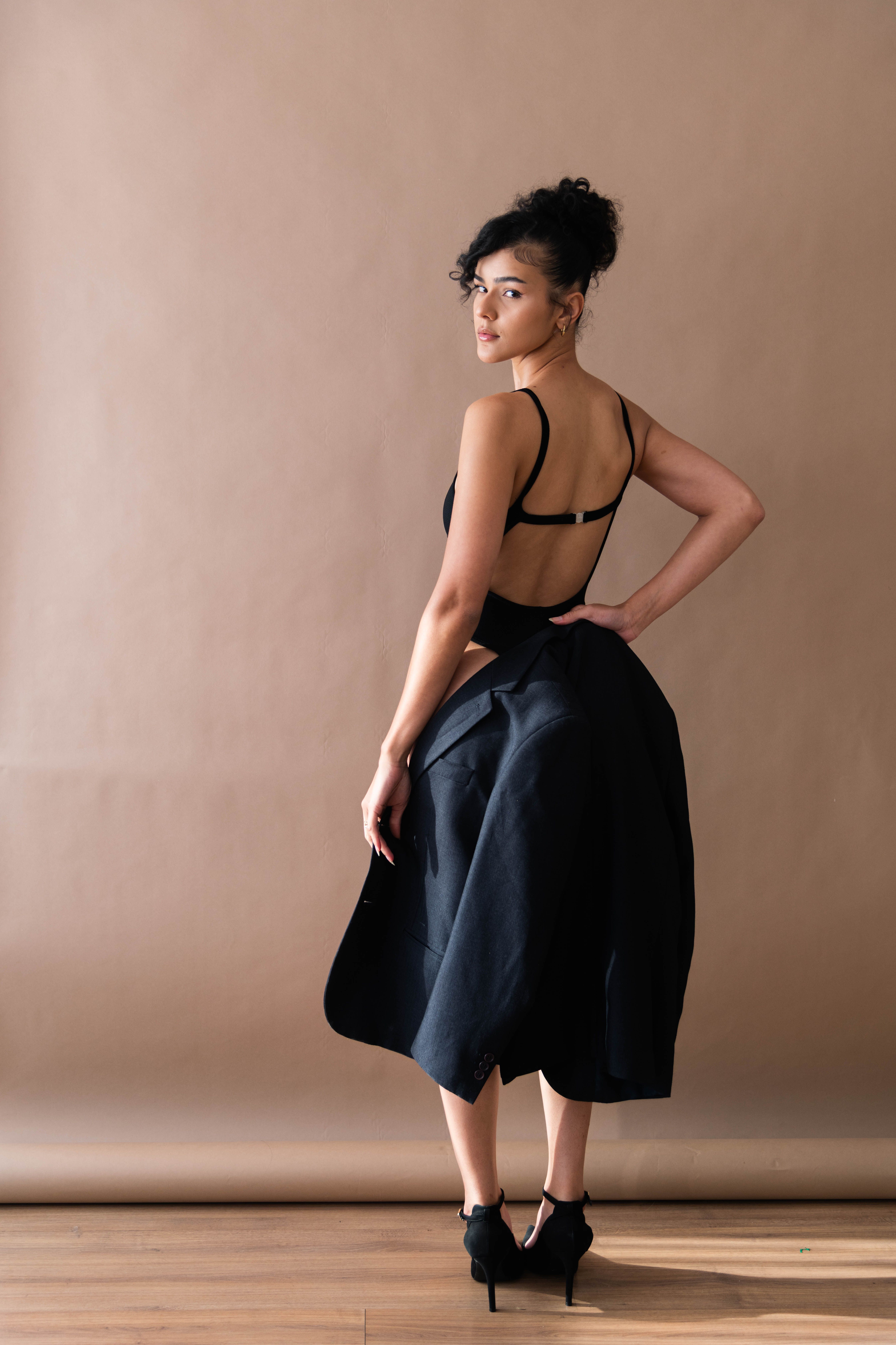 Elegant Woman in Black Dress Posing Indoors · Free Stock Photo