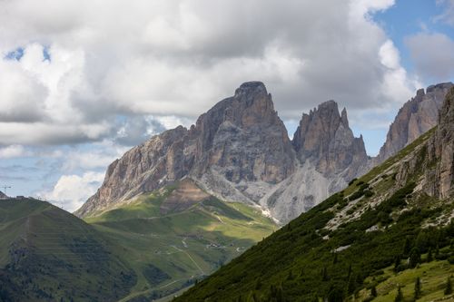 Free Panoramic view of the Dolomites with lush valleys under a dramatic sky in Trentino-South Tyrol. Stock Photo