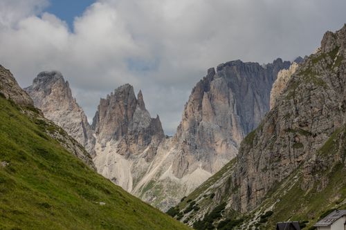 Free Stunning view of the Dolomites peaks surrounded by green valleys under a cloudy sky. Stock Photo