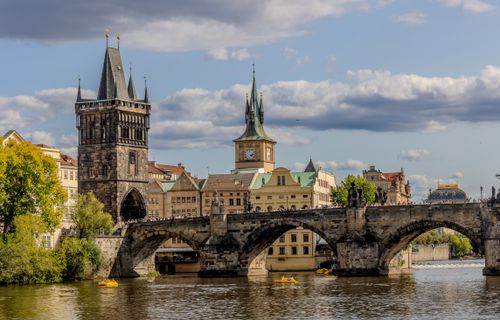 Free Iconic Charles Bridge in Prague with Gothic towers and Vltava River under a sunny sky. Stock Photo