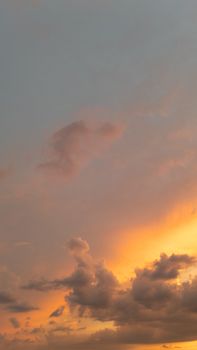 Captivating golden sunset with dramatic clouds in a serene sky.