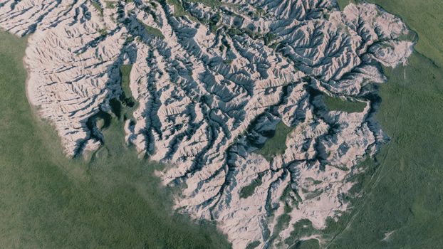 An aerial shot capturing the intricate erosion patterns of the Badlands and surrounding grasslands.
