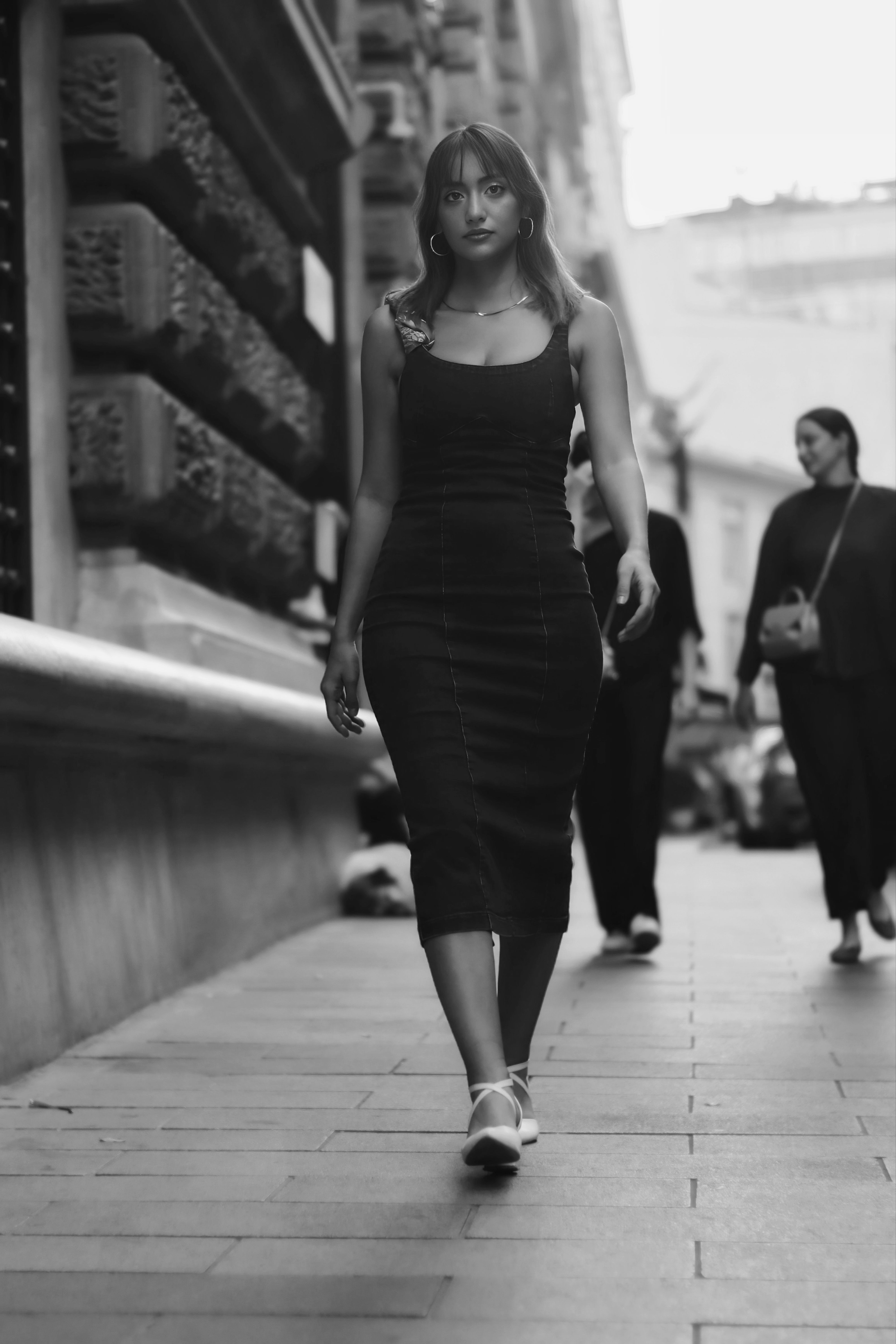 Stylish Woman in Black Dress Walking Down Street · Free Stock Photo