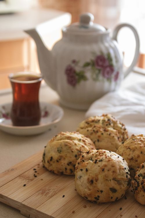 Free Cozy setting with tea, fresh savory biscuits, and floral teapot. Stock Photo
