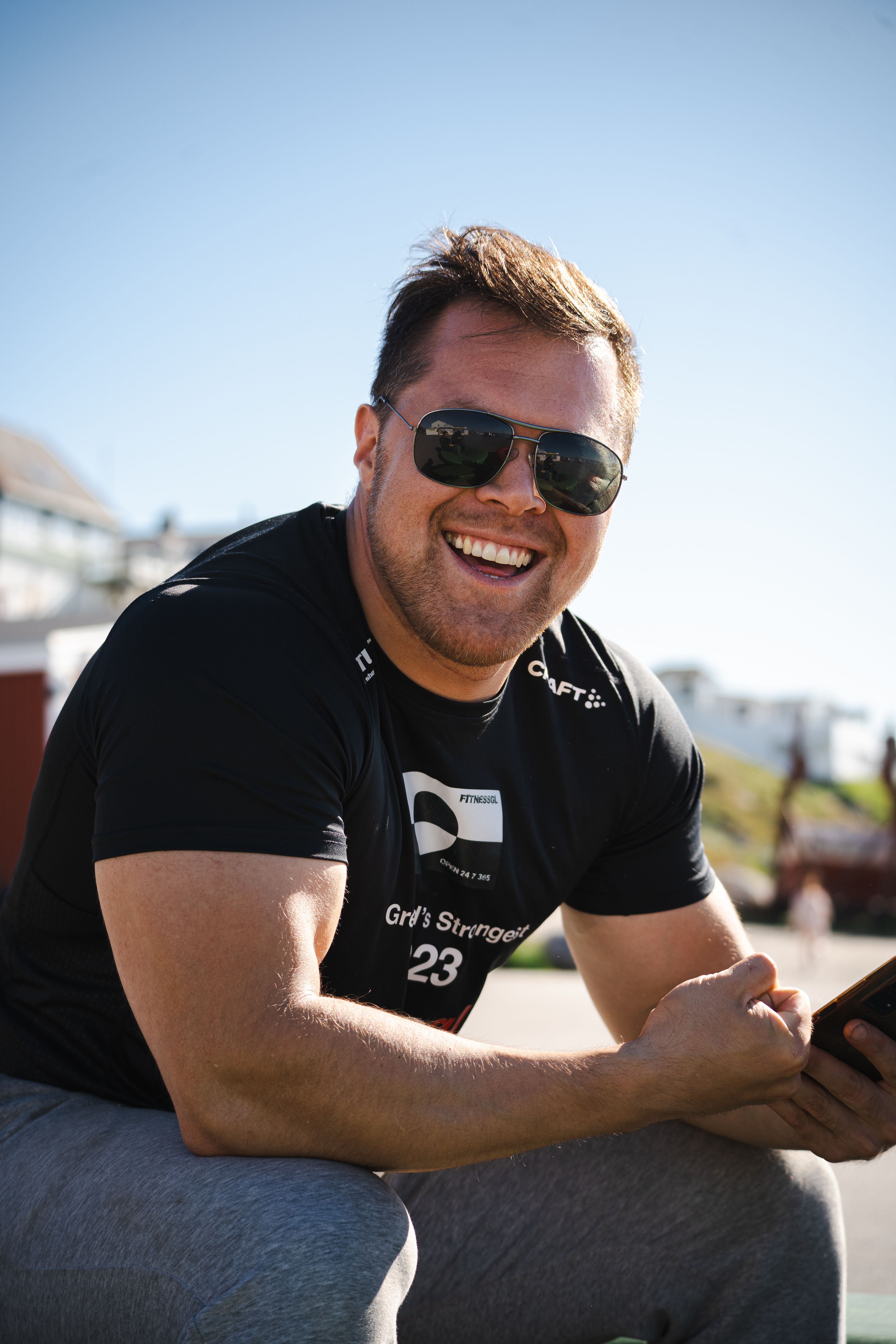 Happy man with sunglasses enjoying a sunny day in Nuuk, Greenland.
