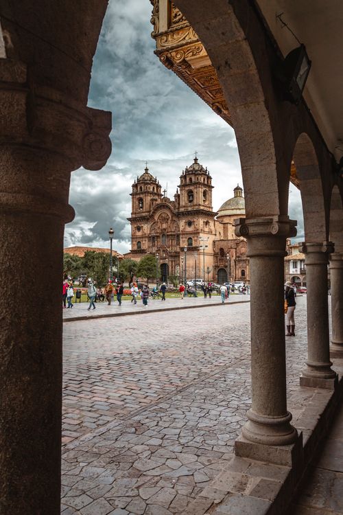 Free Beautiful view of the Church of the Society of Jesus in Cusco's Plaza de Armas under a cloudy sky. Stock Photo