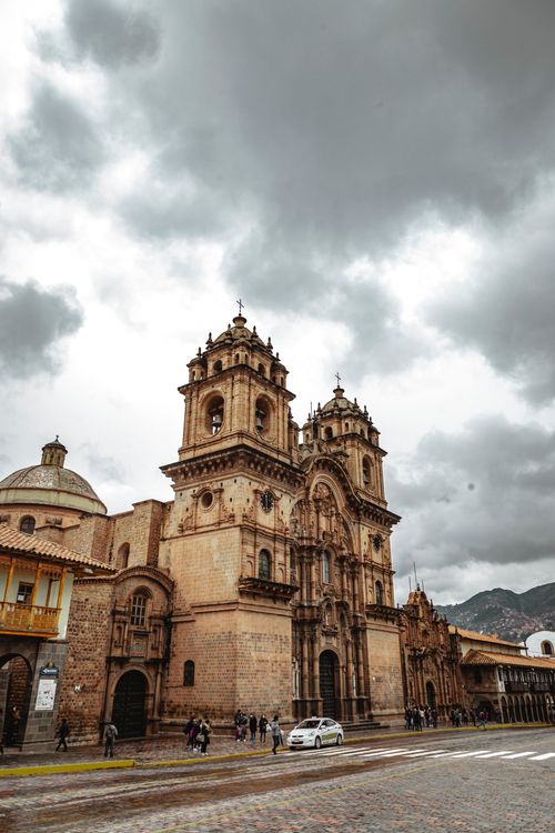 Free The majestic Cusco Cathedral stands tall under a cloudy sky, capturing Cusco's architectural beauty. Stock Photo