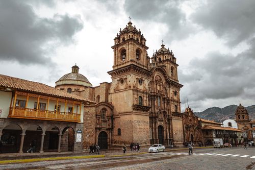 Free The stunning Cusco Cathedral set against a cloudy sky, capturing the rich history and architecture of Peru. Stock Photo