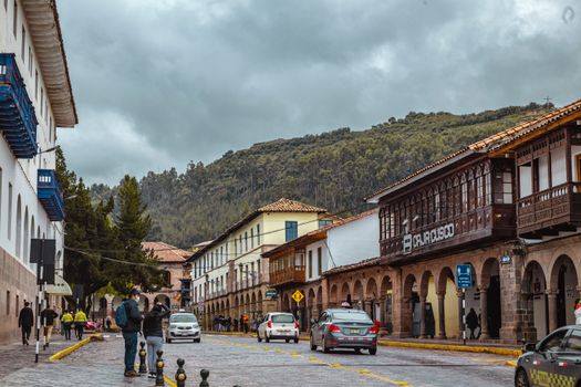 A vibrant street in Cusco, Peru, featuring colonial architecture and bustling activity.