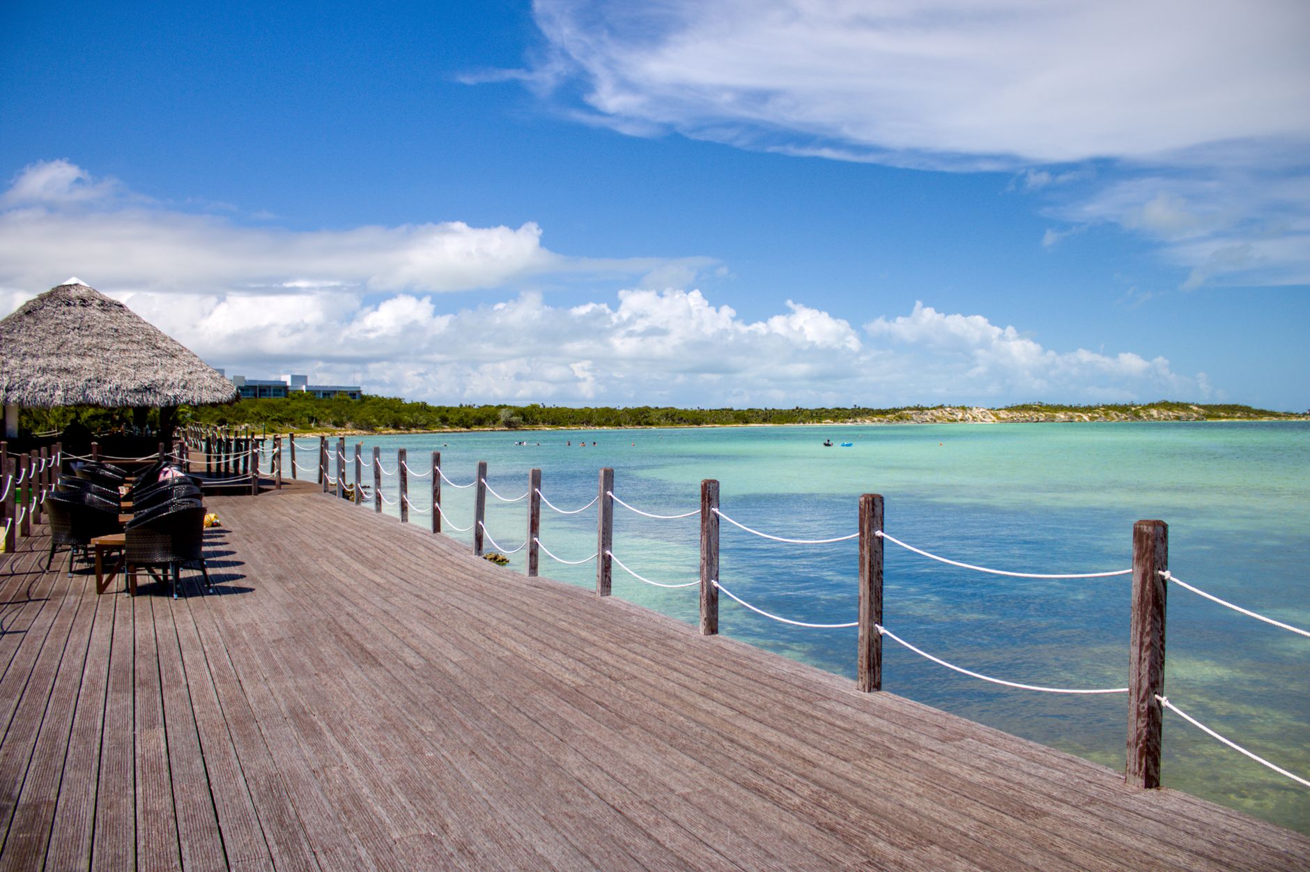 Idyllic view of a wooden boardwalk by the turquoise ocean in Ciego de Ávila, Cuba.