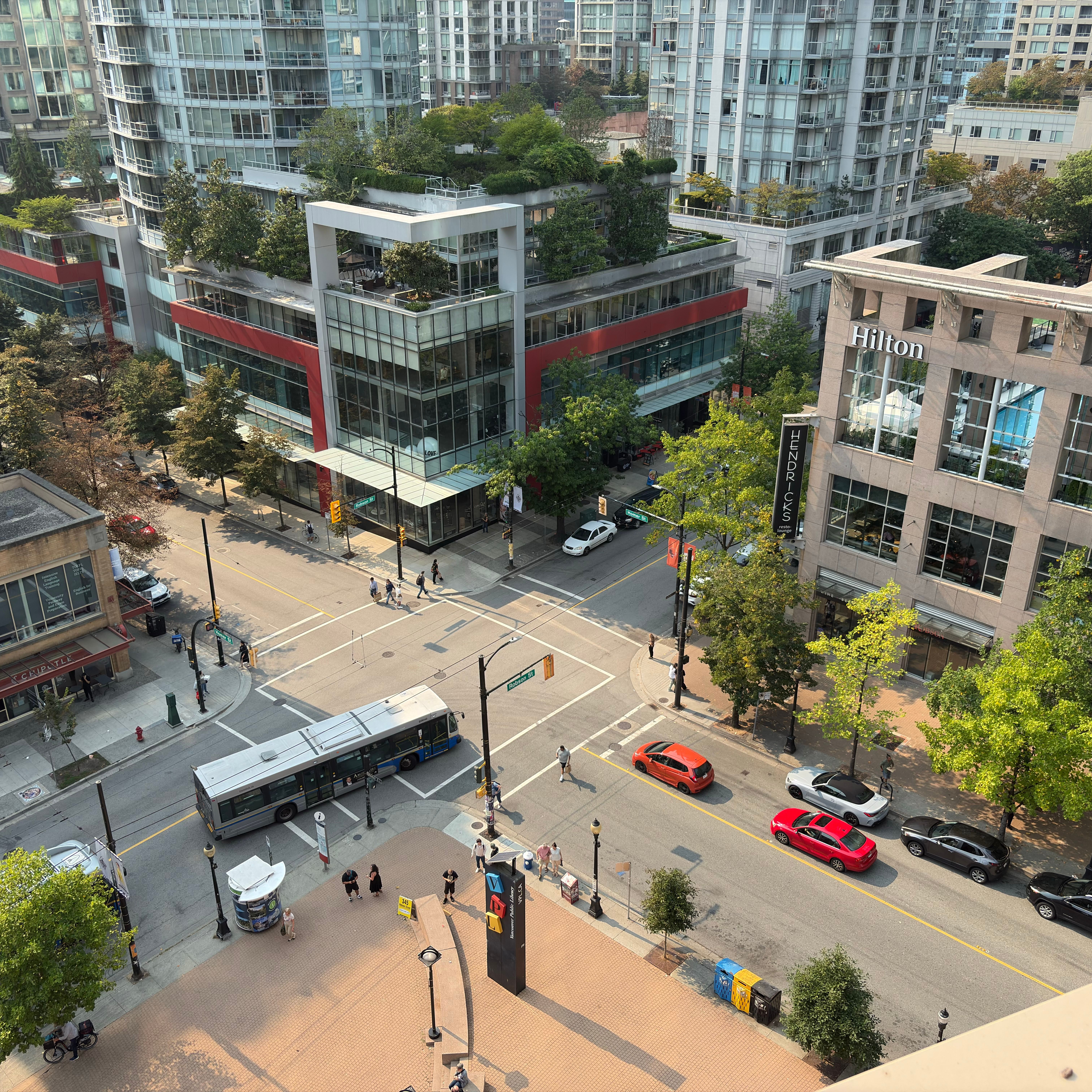 Aerial view of a bustling intersection in downtown Vancouver, BC, showcasing urban life and architecture.
