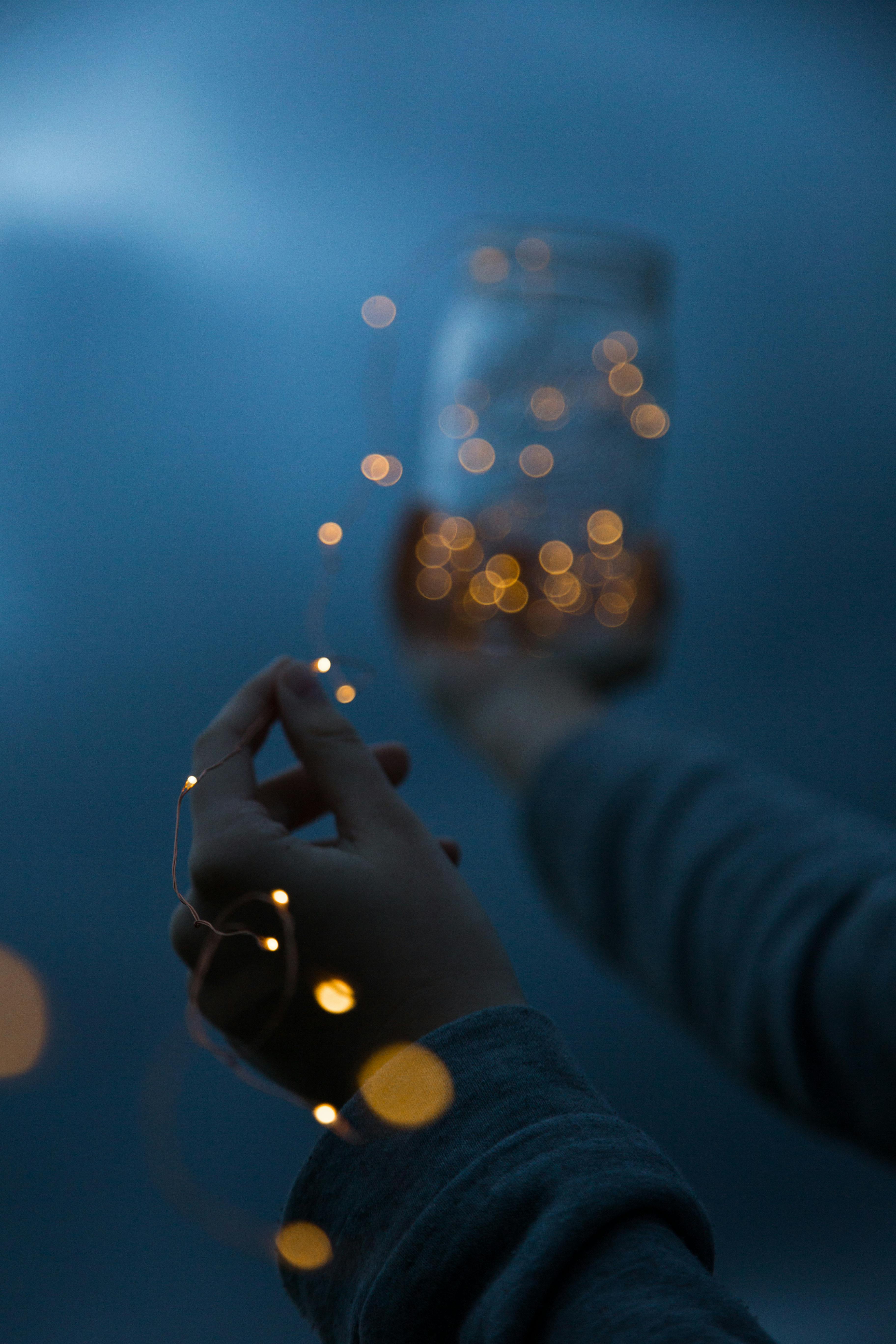 woman holding a yellow string light