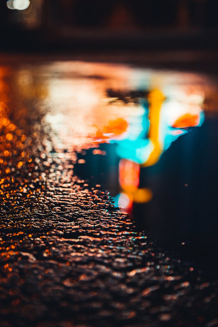 Water Droplets On Black Asphalt Road During Night Time