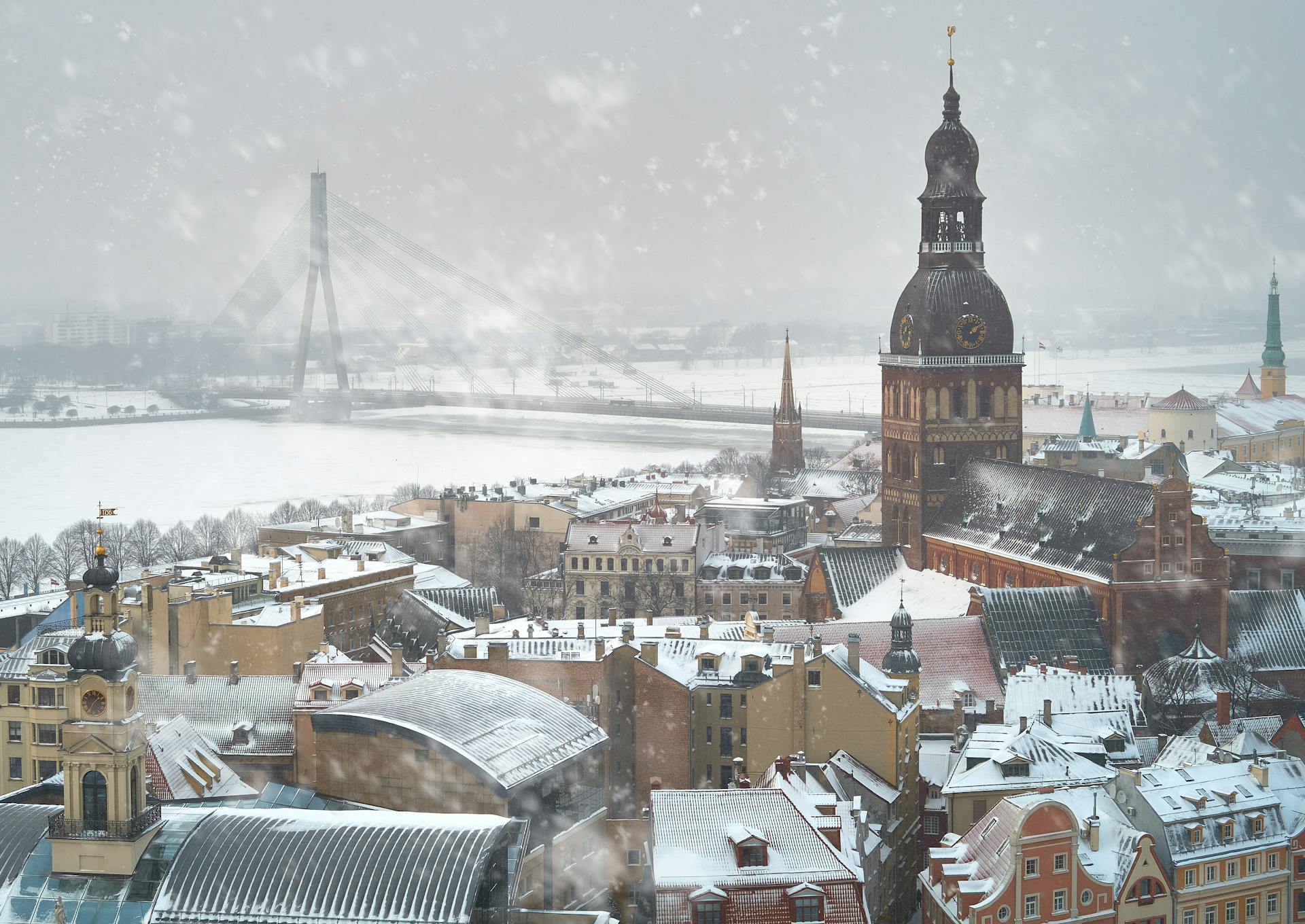 Aerial view of snowy Riga, Latvia showcasing winter cityscape with historical architecture.