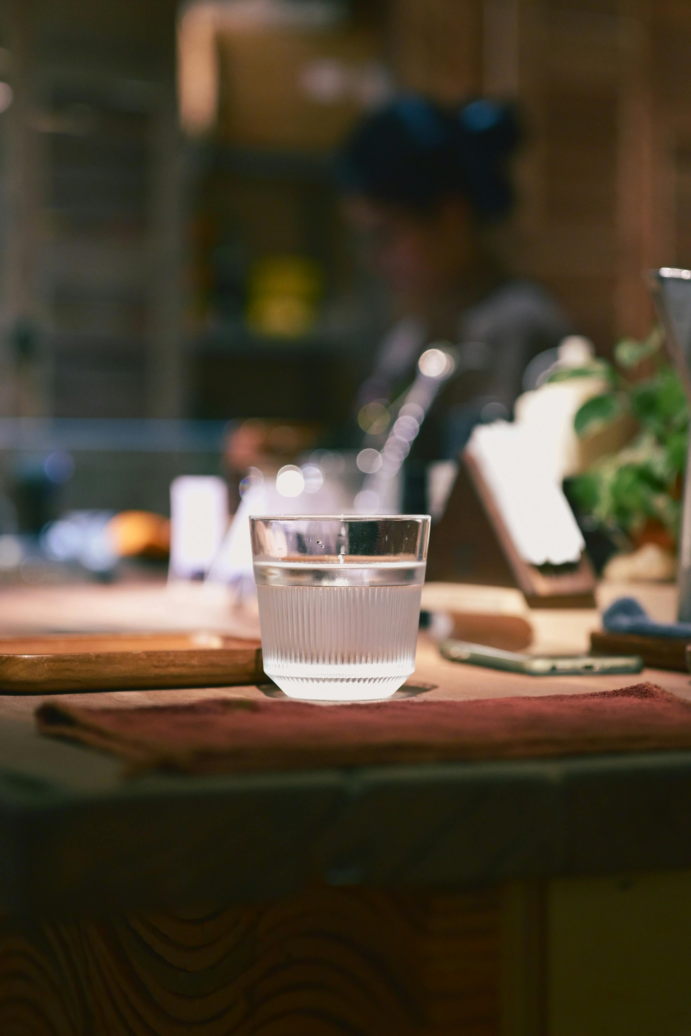 Glass of drinking water on a warm kitchen counter