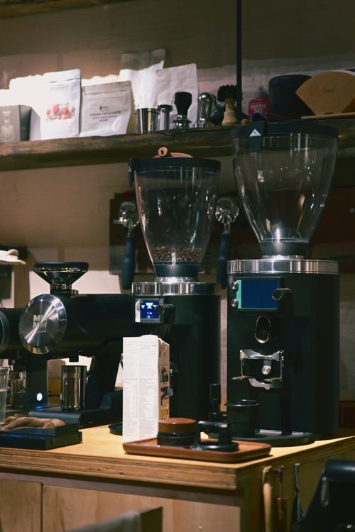 Free Espresso machines and coffee grinders on a wooden counter in a cozy coffee shop. Stock Photo