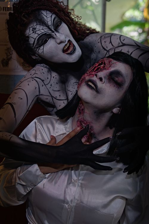 Free Creative Halloween cosplay with horror makeup featuring ghoulish characters in action. Stock Photo