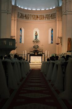 Beautiful church interior with ornate altar and stained glass windows, offering a serene atmosphere.
