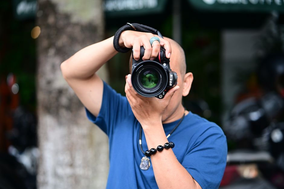 A photographer capturing the moon with a telephoto lens A photographer capturing the moon with a telephoto lens