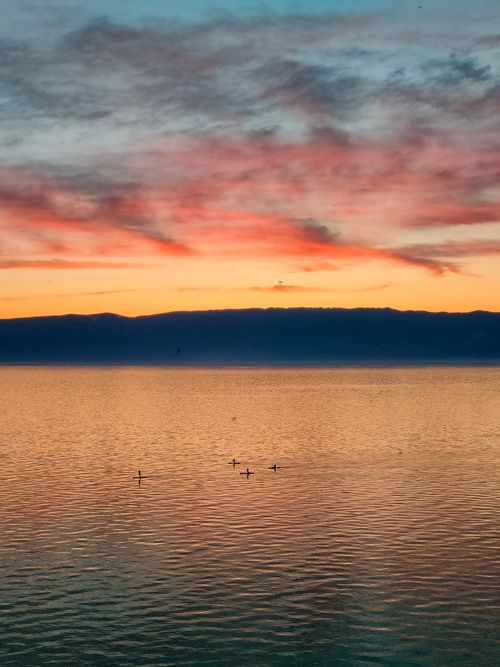 Free Colorful sunset over Lake Baikal with a serene horizon and vibrant sky. Stock Photo