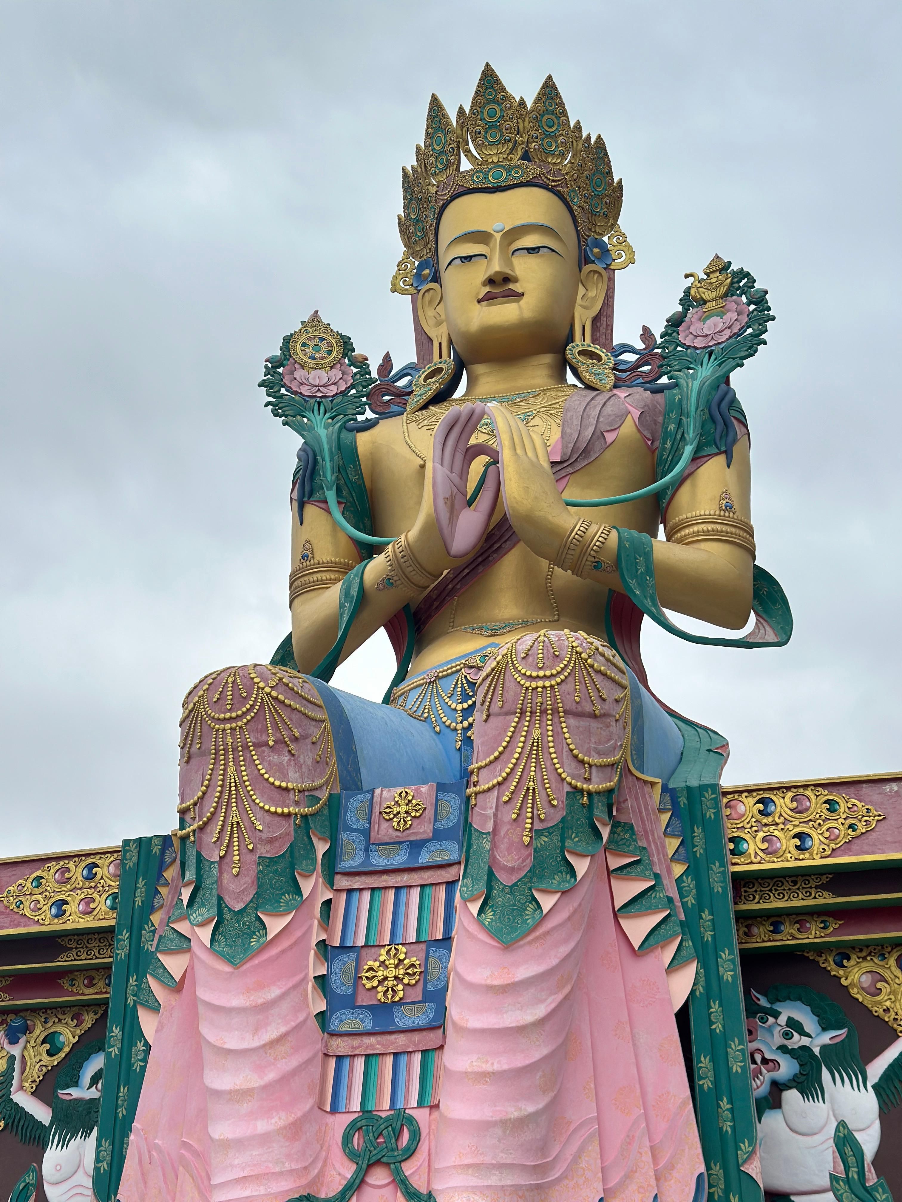 A stunning statue of Buddha in Leh showcasing intricate details and vibrant colors.