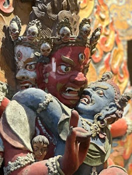 Close-up of a vibrant Tibetan sculpture depicting fierce deities inside a Leh monastery.