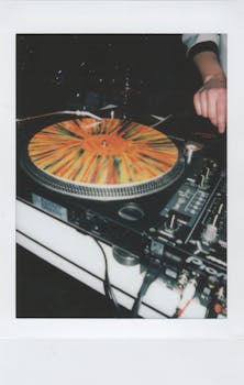 Colorful vinyl on a DJ turntable creating lively party vibes indoors.