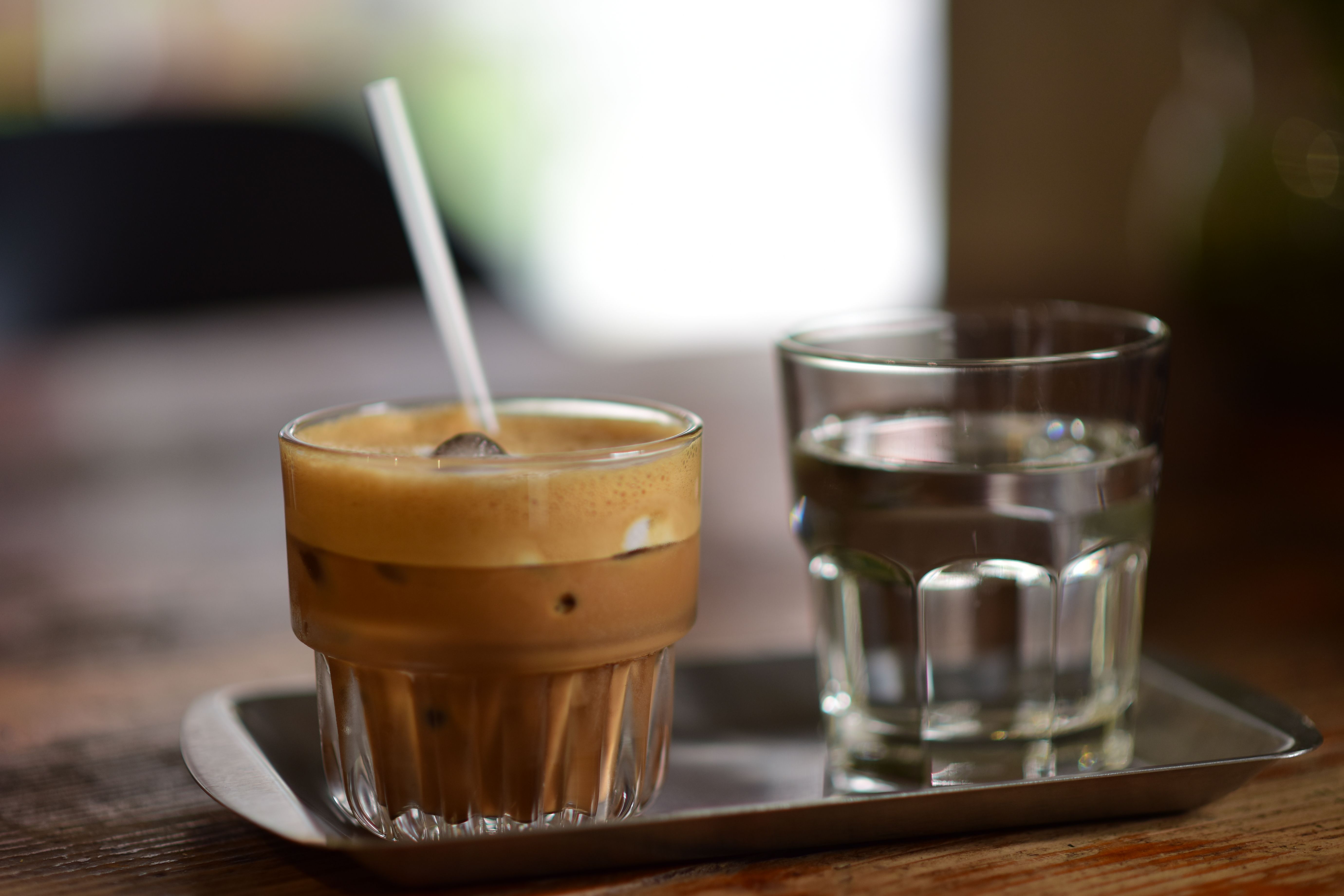 A refreshing freddo espresso on a table at an outdoor cafe in Athens, Greece.
