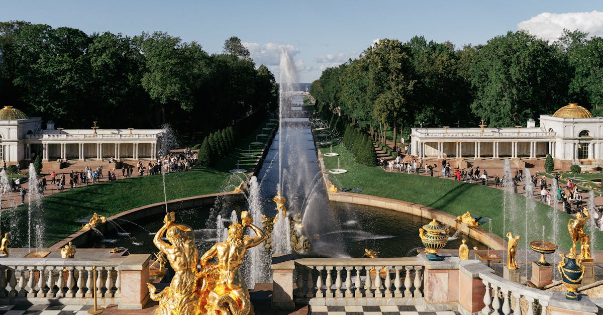 Stunning view of the Grand Cascade fountains at Peterhof Palace with intricate sculptures and lush gardens.