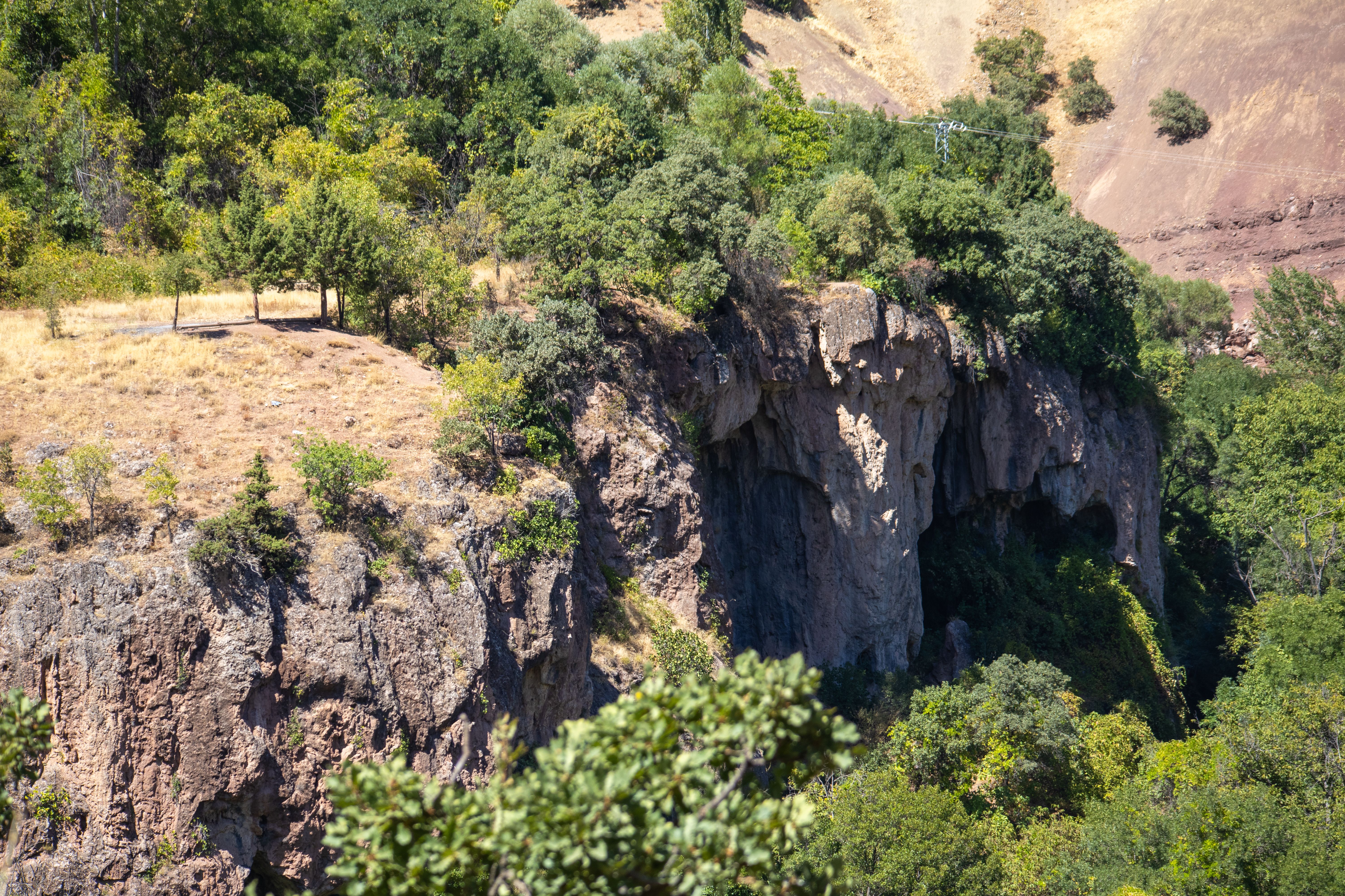 Explore the lush greenery and dramatic cliffs of Munzur Valley in Tunceli, Türkiye, during summer.