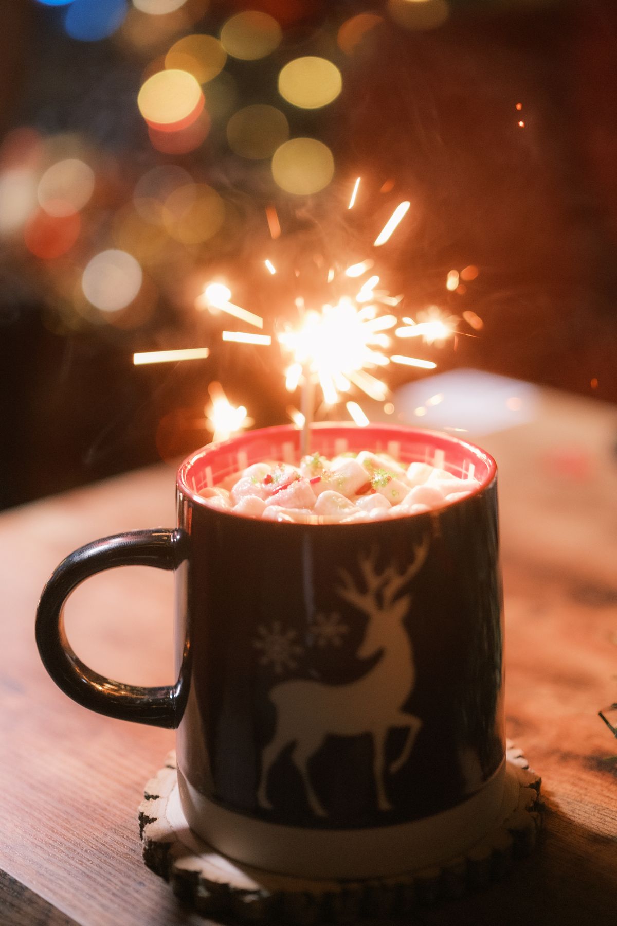 Festive hot chocolate mug with marshmallows and a sparkler