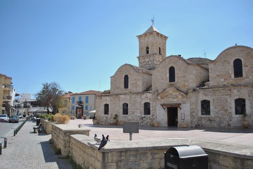 Free Historical St Lazarus Church in Larnaca, Cyprus, under a bright blue sky with pigeons in the foreground. Stock Photo