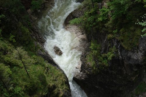 Free Aerial view of a lush green gorge in Germany with a flowing river cutting through the rocks. Stock Photo
