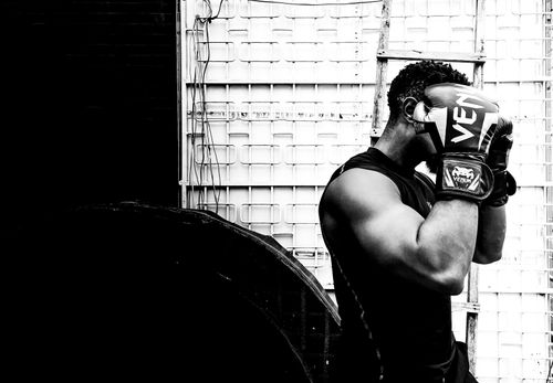 Free Black and white photo of male boxer preparing for a workout in gym. Stock Photo