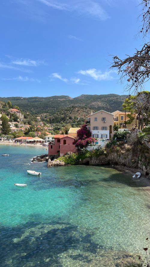 Free Beautiful coastal village with clear blue waters and lush greenery in summer. Stock Photo