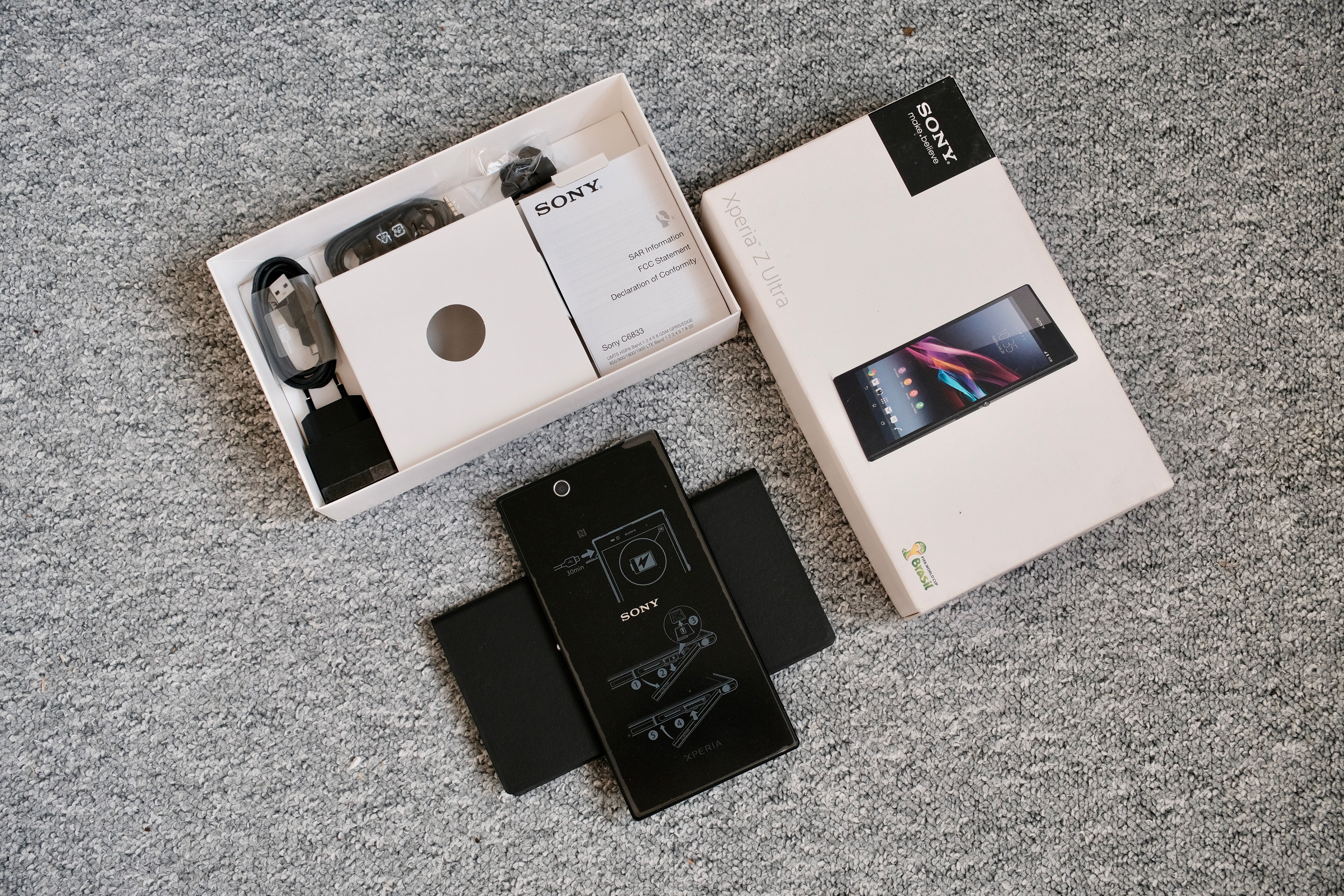 Unboxing of a Mobile Phone with Accessories · Free Stock Photo