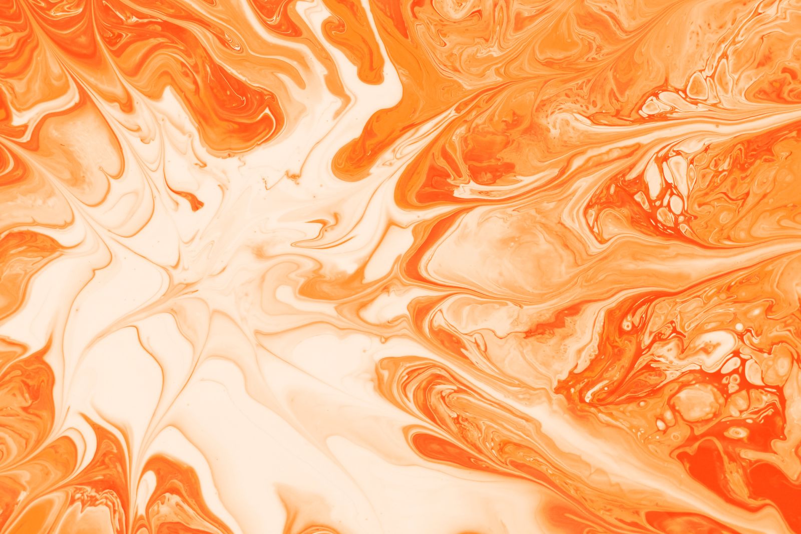 Orange and cream paint swirling on water — photo by Landiva Weber on Pexels