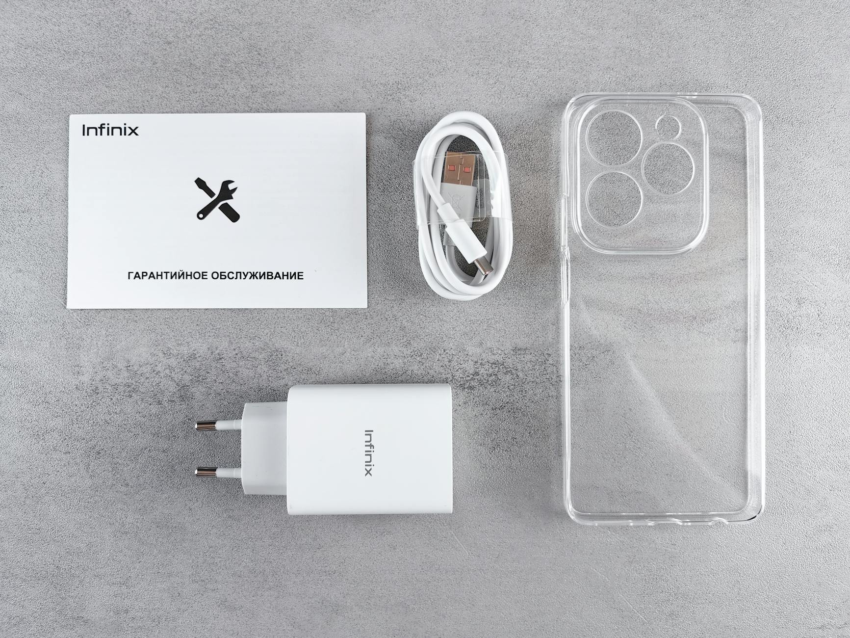 Two smartphones on a warranty card on a desk