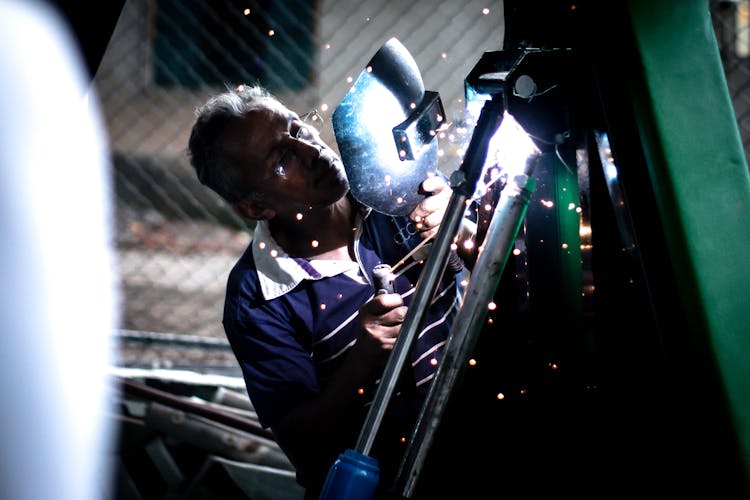 Man Holding Welding Helmet