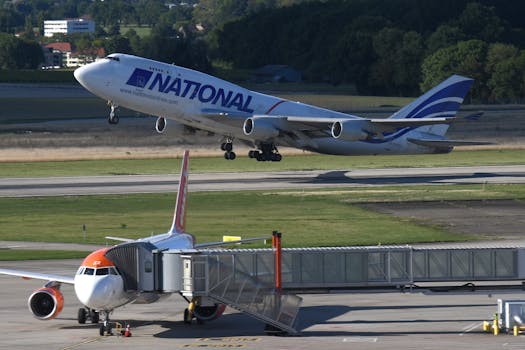 Two airplanes, one taking off and one taxiing, captured at Geneva Airport, Switzerland.