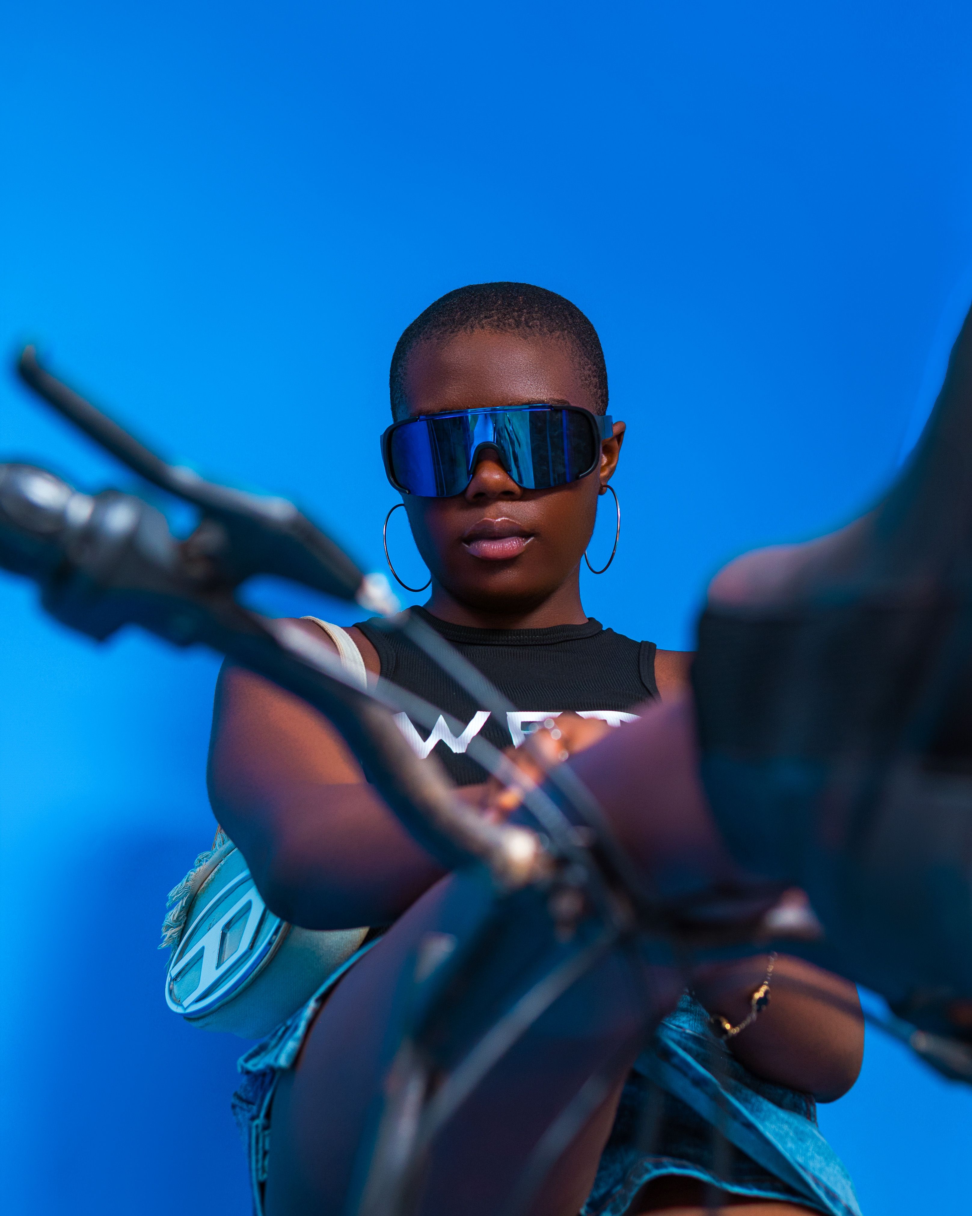 Stylish Woman in Sunglasses Against Blue Background · Free Stock Photo