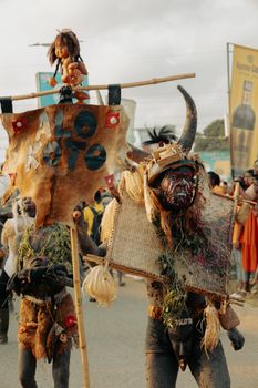 Colorful street festival with masked participants in Cape Coast, Ghana highlighting rich cultural traditions.