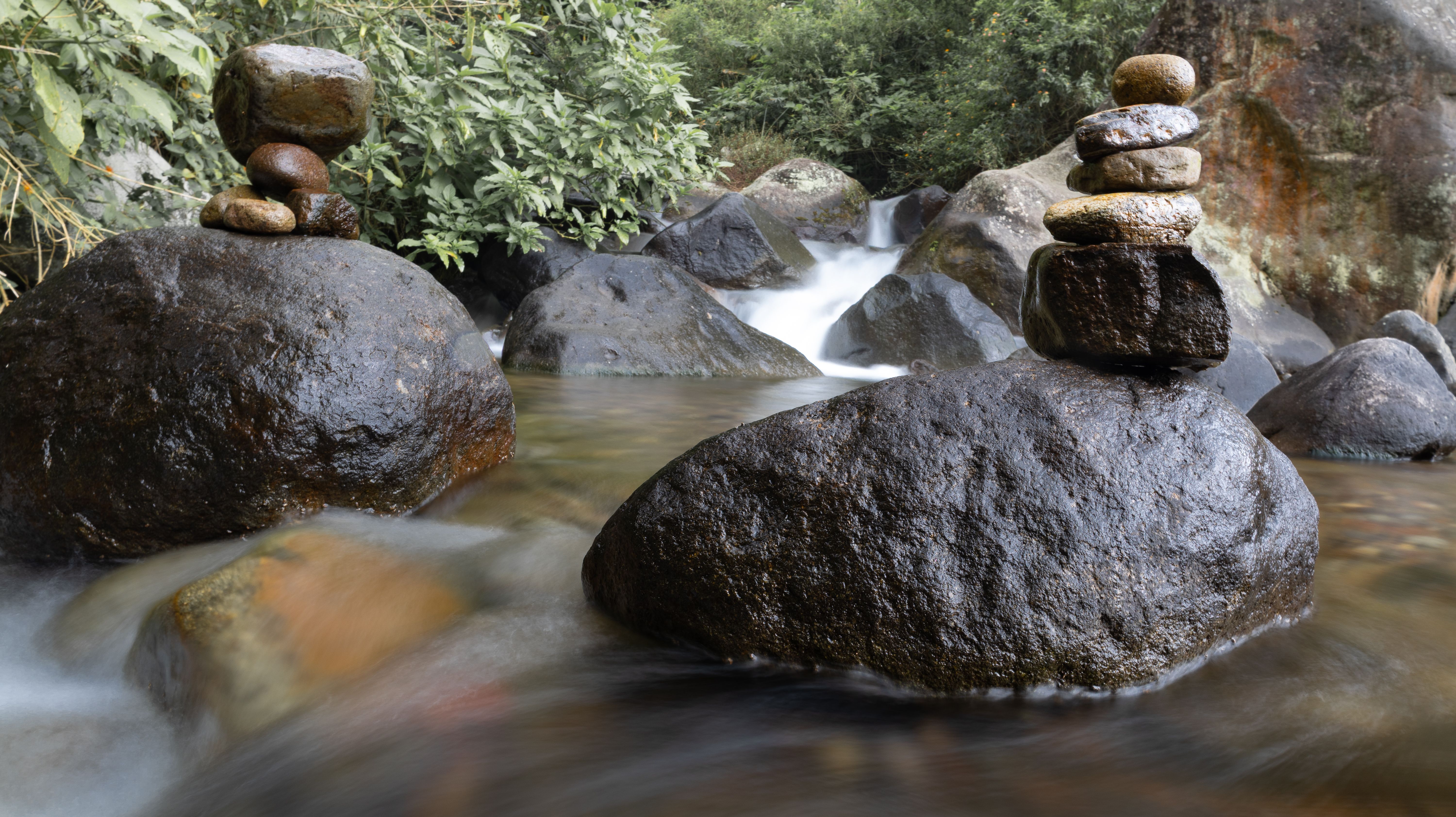 Serene Rock Balancing in Indonesian Jungle Stream · Free Stock Photo