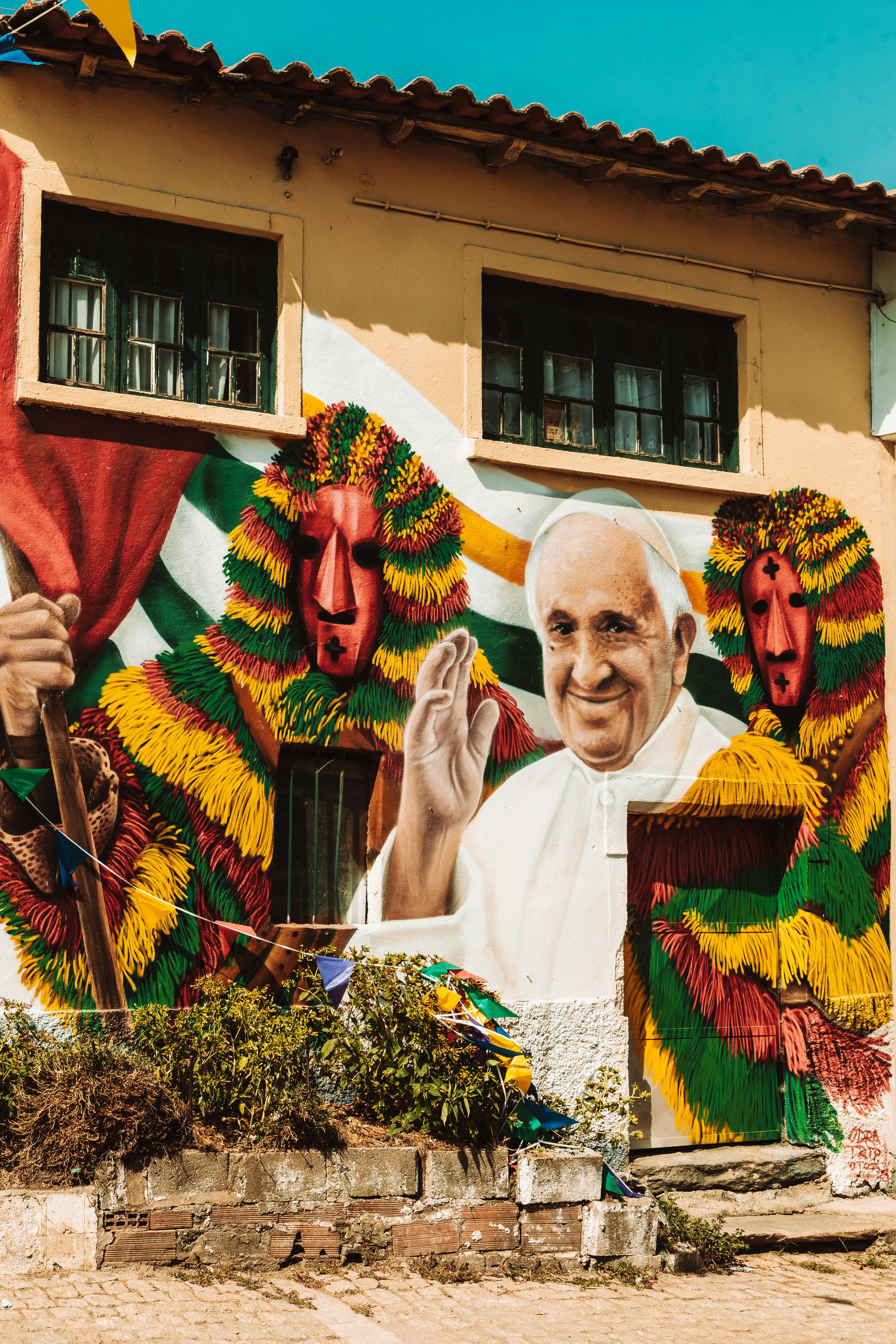 Colorful mural depicting religious and cultural imagery in Macedo de Cavaleiros.