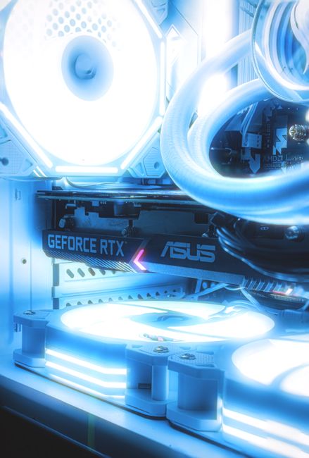 A technician installing a high-end graphics card into a PC case to meet RTX 5090 power requirements.