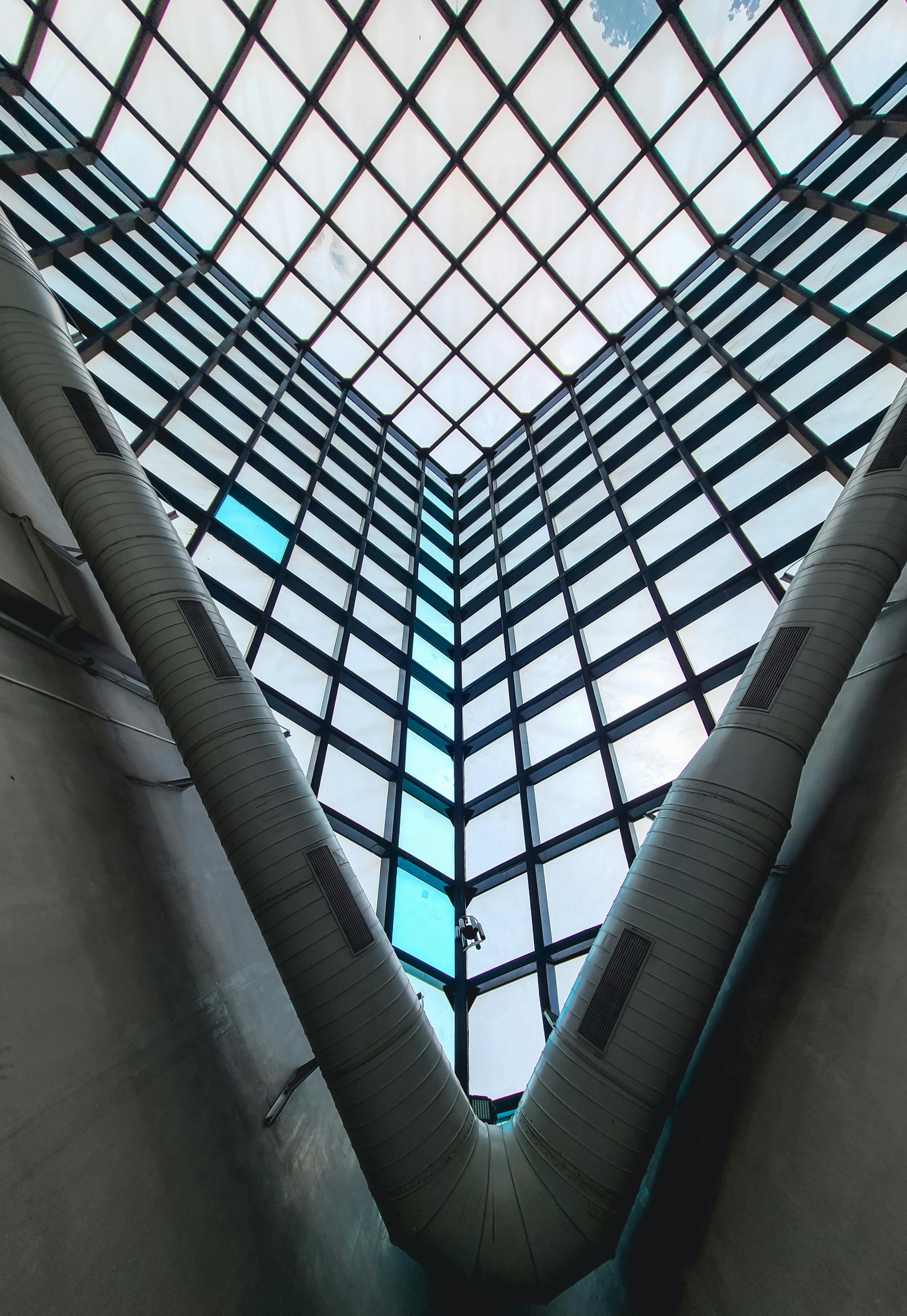 A modern architectural interior with a striking skylight and geometric patterns.
