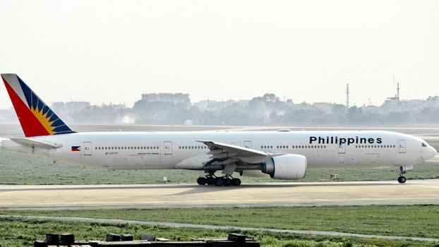 Philippine Airlines commercial aircraft on a runway, ready for takeoff.