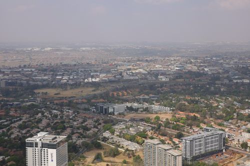 Free Expansive aerial view of a modern city landscape under clear skies. Stock Photo